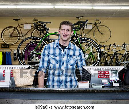 Cashier working in bicycle shop View Large Photo Image Stock Photograph - Cashier working in bicycle shop. Fotosearch