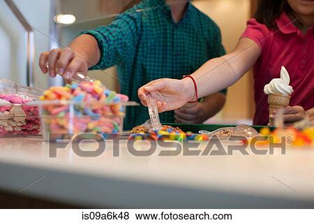 Children choosing toppings in store View Large Photo Image Stock Photo - Children choosing toppings in store. Fotosearch