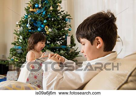 Picture - Children opening Christmas gifts. Fotosearch