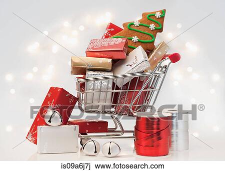 Stock Image - Christmas gifts and cookie in cart. Fotosearch