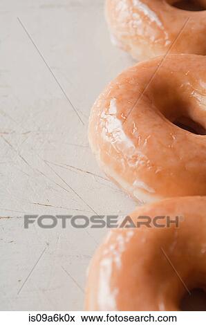 Stock Photo - Close up of glazed doughnuts. Fotosearch