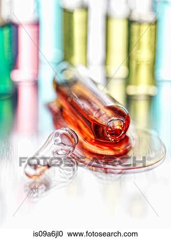 Stock Image - Close up of spilled vial of liquid. Fotosearch