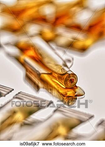 Close up of spilled vial of liquid View Large Photo Image Stock Photo - Close up of spilled vial of liquid. Fotosearch