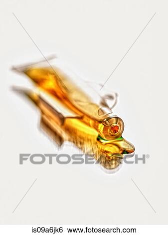 Stock Photograph - Close up of spilled vial of liquid. Fotosearch