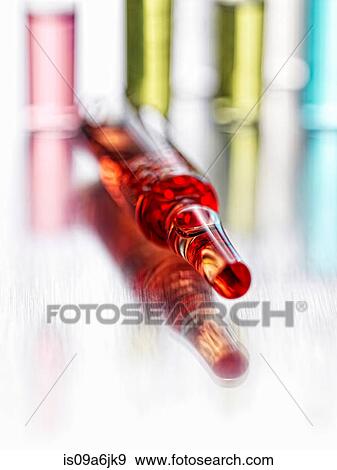 Close up of vial of liquid View Large Photo Image Stock Photo - Close up of vial of liquid. Fotosearch