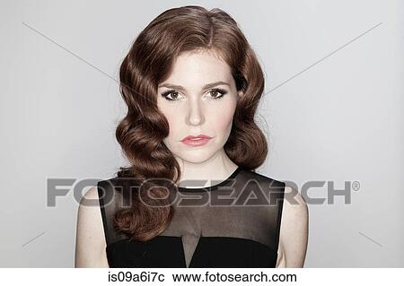 Stock Image - Close up of woman's serious face. Fotosearch