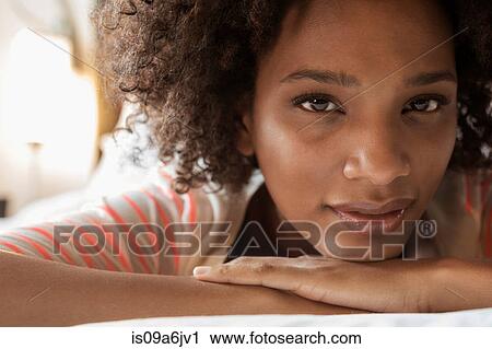 Stock Image - Close up of woman's serious face. Fotosearch