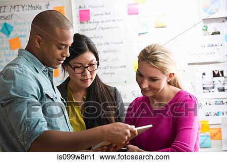 Colleagues using digital tablet View Large Photo Image Stock Image - Colleagues using digital tablet. Fotosearch