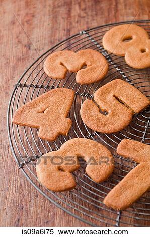 Cookies in number shapes on cooling rack View Large Photo Image Stock Photography - Cookies in number shapes on cooling rack. Fotosearch