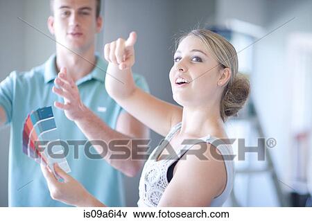 Couple discussing home renovations View Large Photo Image Stock Photo - Couple discussing home renovations. Fotosearch