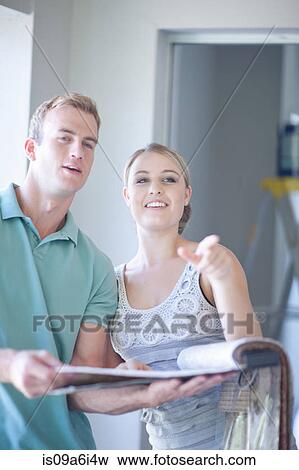 Stock Photo - Couple discussing home renovations. Fotosearch