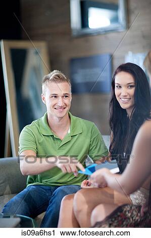 Stock Image - Couple examining swatches in store. Fotosearch