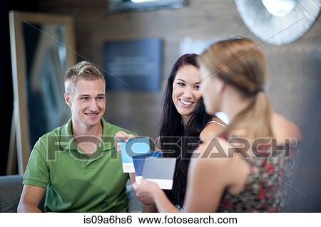 Couple examining swatches in store View Large Photo Image Stock Photograph - Couple examining swatches in store. Fotosearch