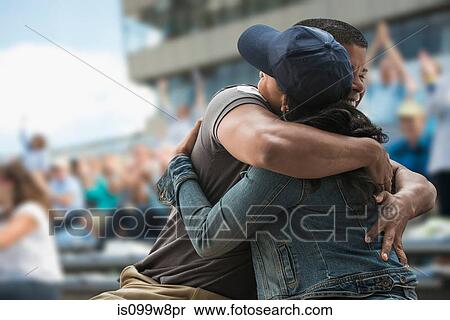 Couple hugging at sports game View Large Photo Image Stock Photography - Couple hugging at sports game. Fotosearch