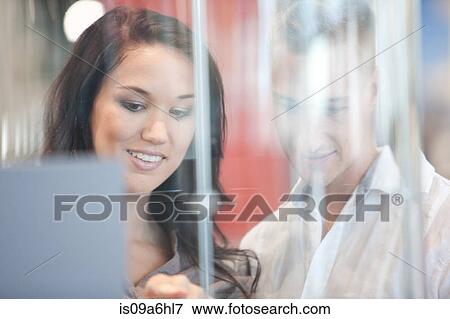 Stock Photo - Couple looking in glass case. Fotosearch