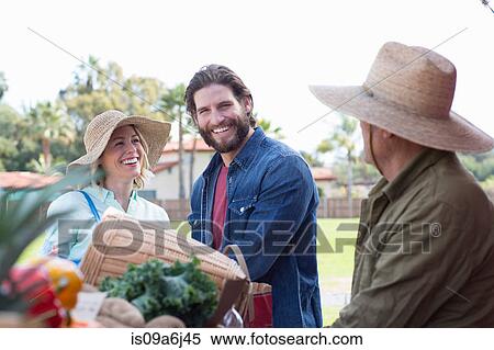 Stock Photography - Couple shopping at farmer's market. Fotosearch