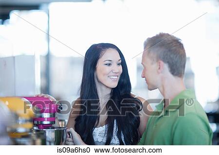 Stock Image - Couple shopping for kitchenware in store. Fotosearch