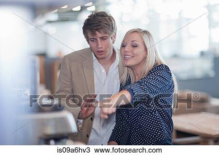 Stock Image - Couple shopping for kitchenware in store. Fotosearch