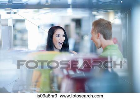 Stock Photo - Couple shopping for kitchenware in store. Fotosearch