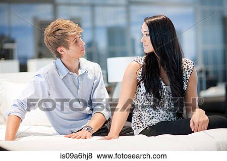 Stock Photo - Couple shopping for mattress in store. Fotosearch