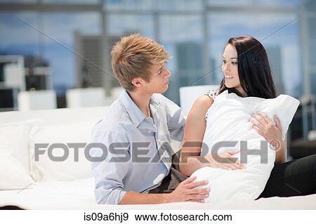Stock Photo - Couple shopping for mattress in store. Fotosearch