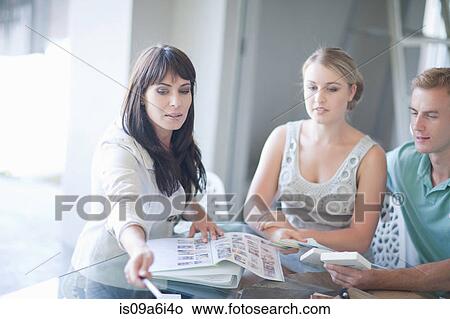 Picture - Couple talking with interior decorator. Fotosearch