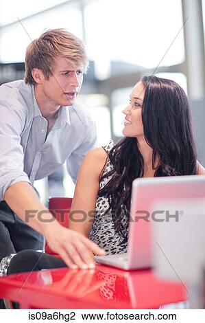 Couple using laptop together at desk View Large Photo Image Stock Image - Couple using laptop together at desk. Fotosearch