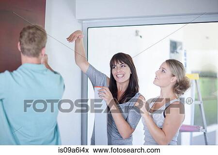 Stock Photo - Couple working with interior designer. Fotosearch