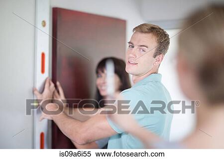 Stock Photography - Couple working with interior designer. Fotosearch