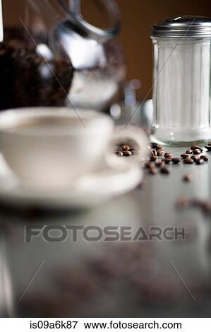 Cup of cappuccino with coffee beans View Large Photo Image Stock Photo - Cup of cappuccino with coffee beans. Fotosearch