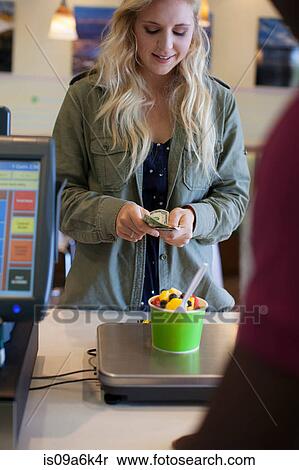 Customer paying for frozen yogurt View Large Photo Image Stock Photography - Customer paying for frozen yogurt. Fotosearch