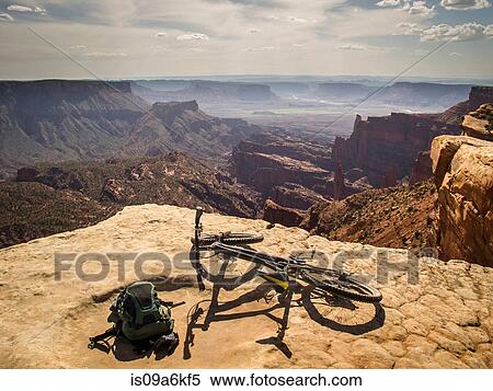Stock Photography - Dirt bike sitting on rocky overlook. Fotosearch