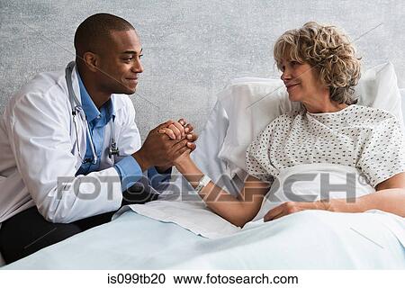 Doctor holding patient's hand View Large Photo Image Stock Image - Doctor holding patient's hand. Fotosearch