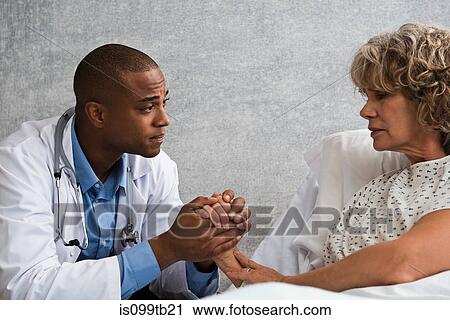 Doctor holding patient's hand View Large Photo Image Stock Image - Doctor holding patient's hand. Fotosearch