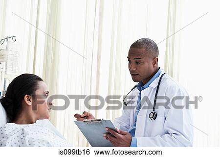 Doctor talking to patient in hospital View Large Photo Image Stock Photograph - Doctor talking to patient in hospital. Fotosearch