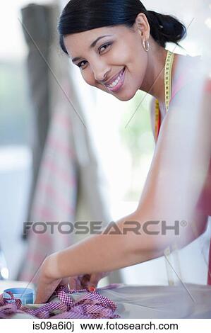 Dressmaker smiling in studio View Large Photo Image Stock Image - Dressmaker smiling in studio. Fotosearch
