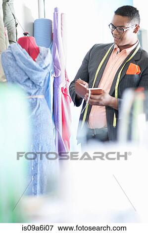 Stock Photo - Dressmaker working in studio. Fotosearch
