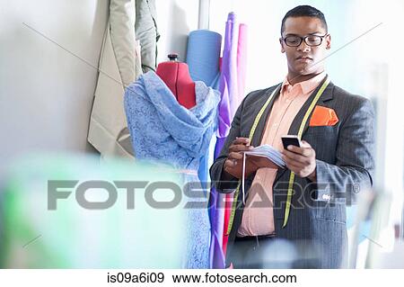 Stock Photo - Dressmaker working in studio. Fotosearch
