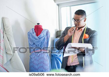 Stock Photograph - Dressmaker working in studio. Fotosearch
