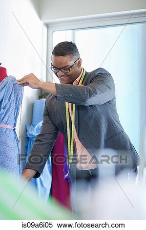 Stock Photography - Dressmaker working in studio. Fotosearch