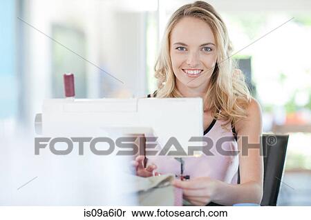 Stock Photography - Dressmaker working in studio. Fotosearch