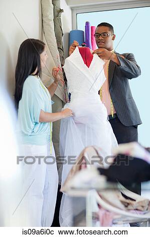 Stock Image - Dressmakers working in studio. Fotosearch