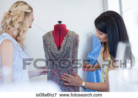 Stock Photo - Dressmakers working in studio. Fotosearch