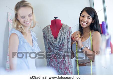 Stock Photo - Dressmakers working in studio. Fotosearch