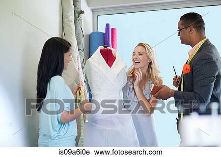 Dressmakers working with client View Large Photo Image Stock Image - Dressmakers working with client. Fotosearch