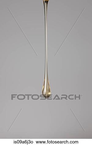 Drop of gold paint View Large Photo Image Picture - Drop of gold paint. Fotosearch