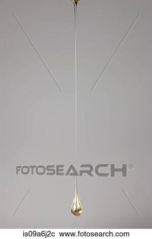 Stock Image - Drop of gold paint. Fotosearch