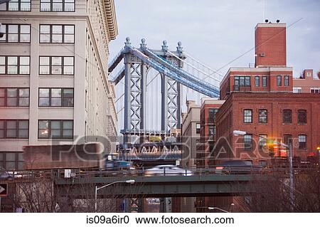 Stock Image - East River Bridge and urban buildings. Fotosearch