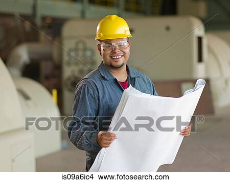 Engineer reading blueprints on site View Large Photo Image Picture - Engineer reading blueprints on site. Fotosearch