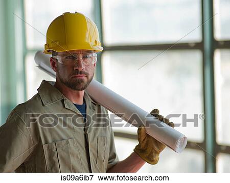 Stock Photo - Engineer wearing hard hat on site. Fotosearch
